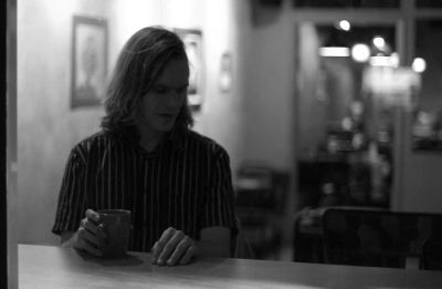 Matthew Hope Sitting At a Counter with Coffee