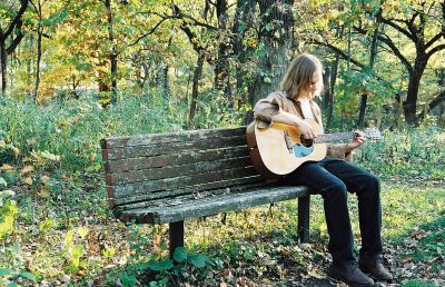 Matthew Hope Playing on a Park Bench